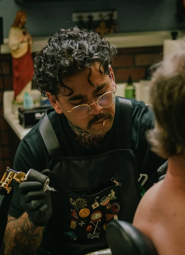Dylan Prorok tattooing in the studio.